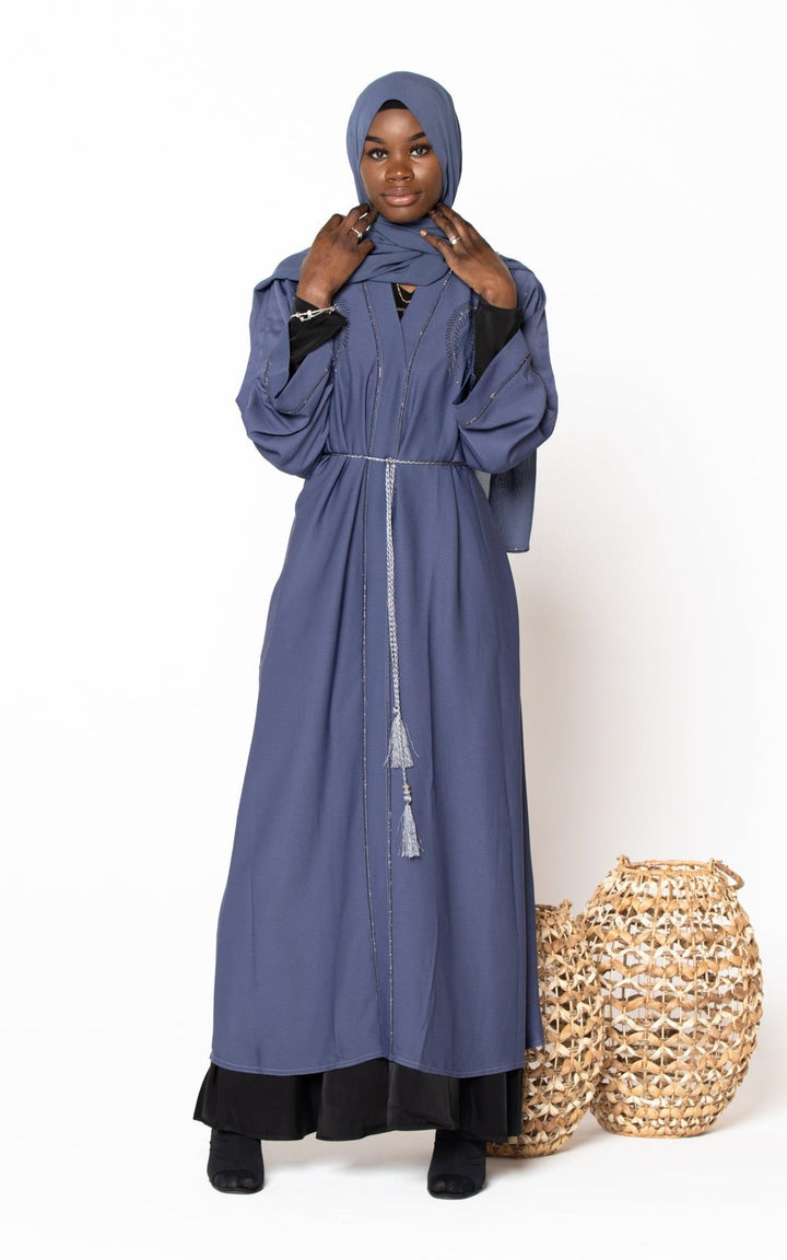 Woman in a blue Jamilah Sequin Open Front Abaya with hijab, showcasing elegance