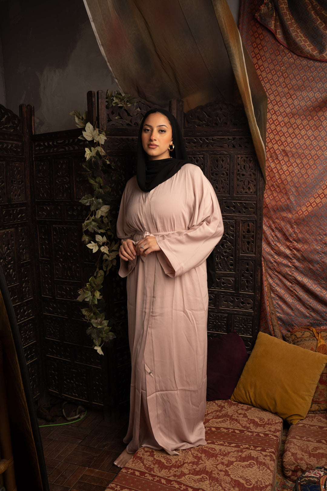 Woman in a light pink dress and black hijab, showcasing Khaki Sleeveless Dress and Open Abaya Set