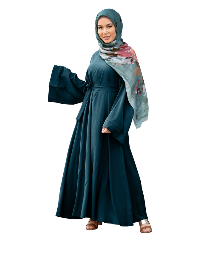 Elegant teal maxi dress with kimono sleeves and floral hijab, featuring a fabric tie belt