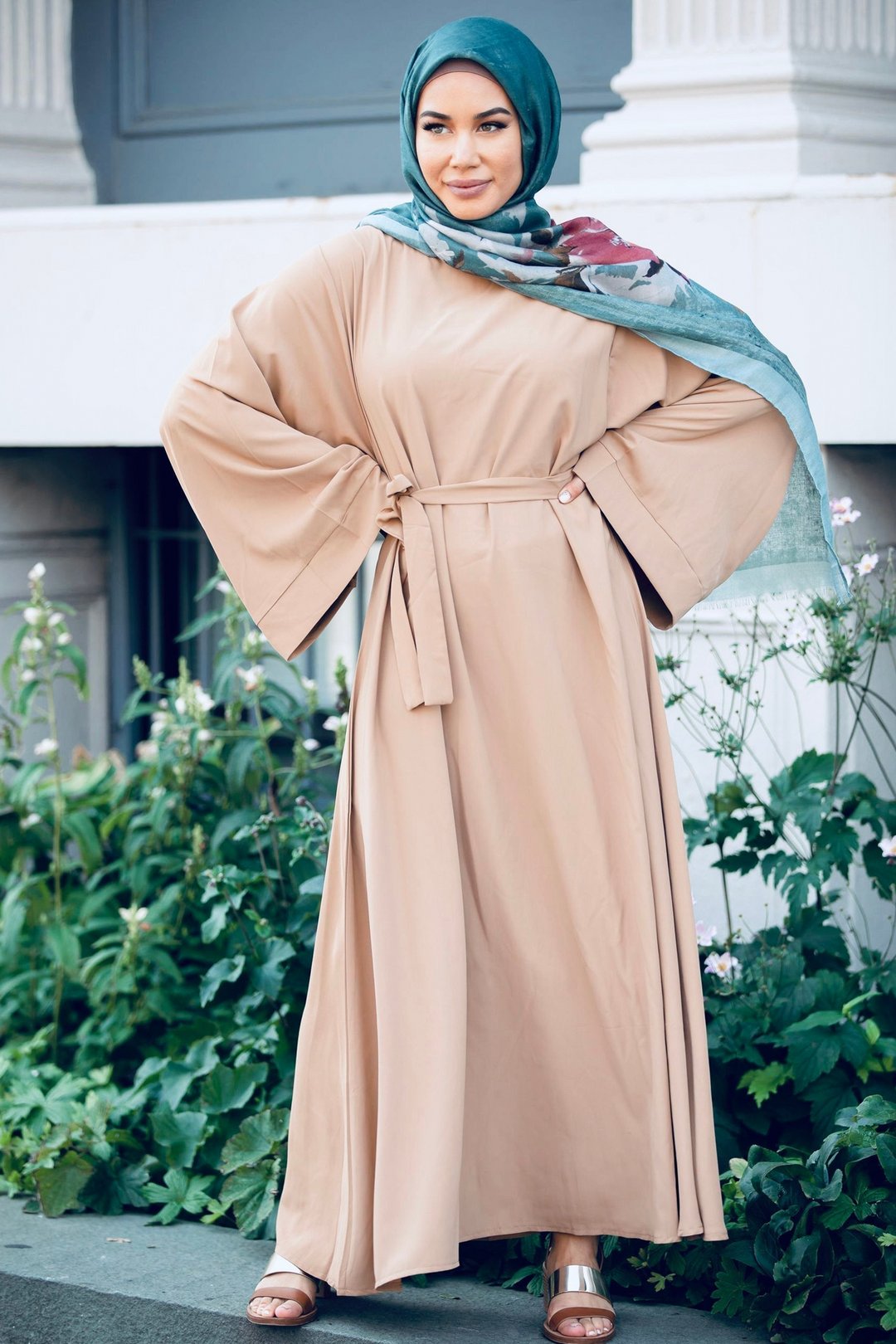 Tan maxi dress with kimono sleeves and fabric tie belt, paired with teal hijab