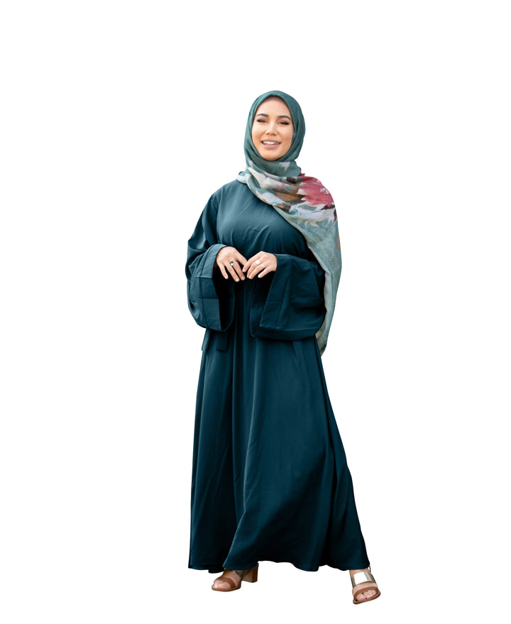 Elegant teal abaya with floral hijab and fabric tie belt in a stylish maxi dress