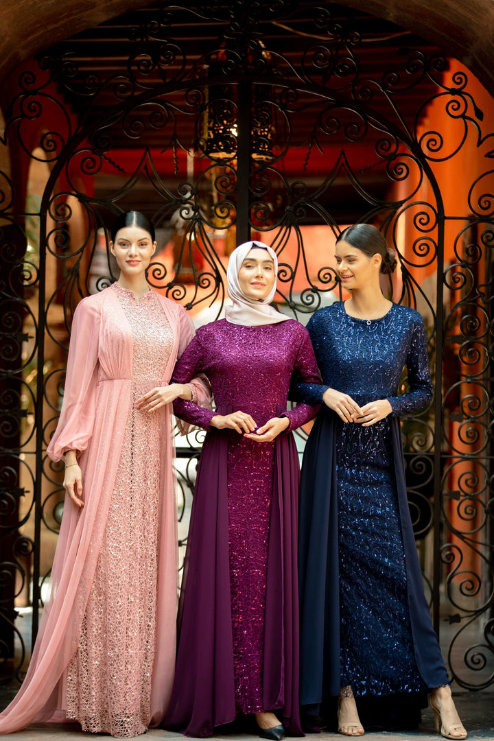 Three women in elegant dresses featuring a lace design and chiffon skirt overlay