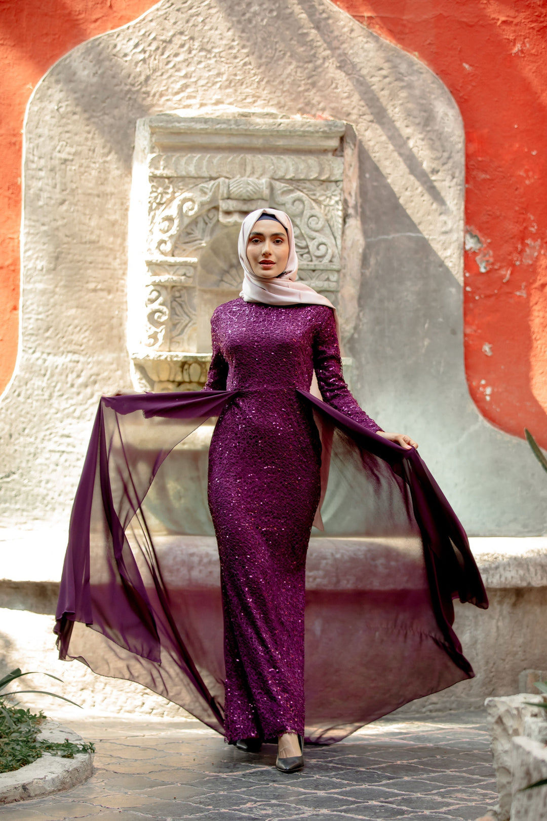 Elegant purple sequined gown with flowing cape and skirt overlay for a stunning look