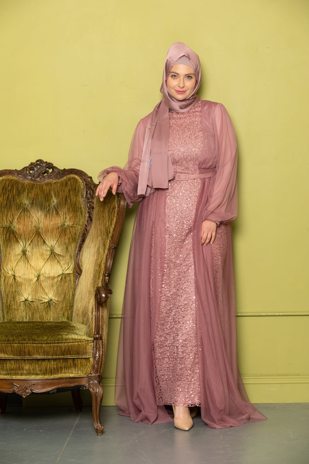 Woman in mauve sequined dress and hijab showcasing a chic chiffon overlay gown