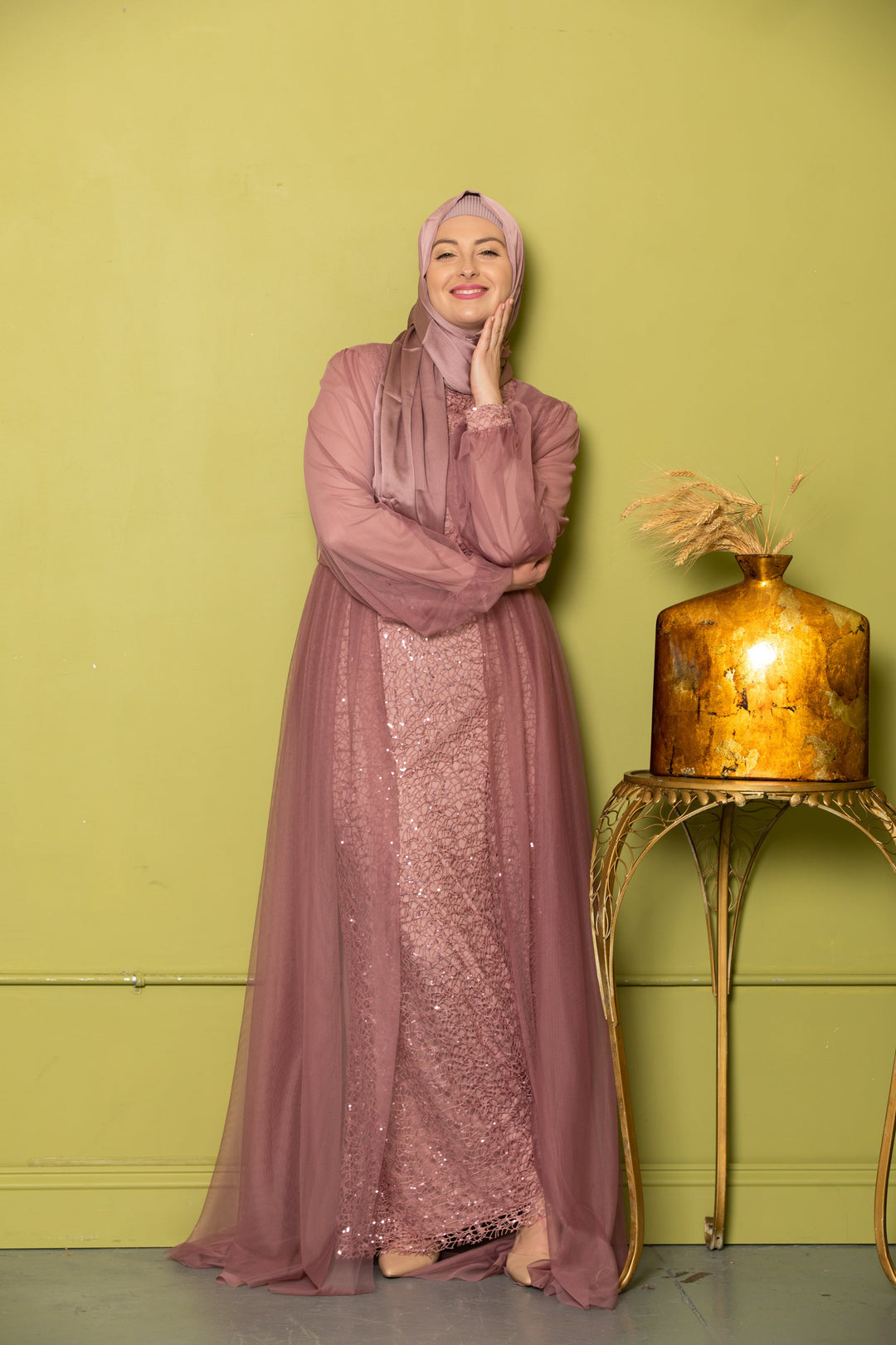 Woman in mauve dress and hijab wearing a Lace With Chiffon Overlay Gown