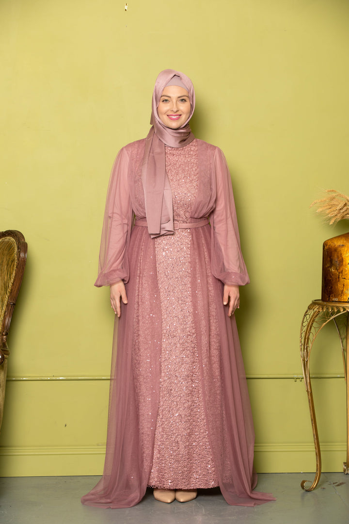 Woman in a mauve chiffon overlay gown with hijab showcasing elegant style