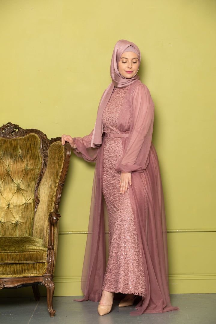 Woman in a mauve chiffon overlay gown with hijab, showcasing elegant style