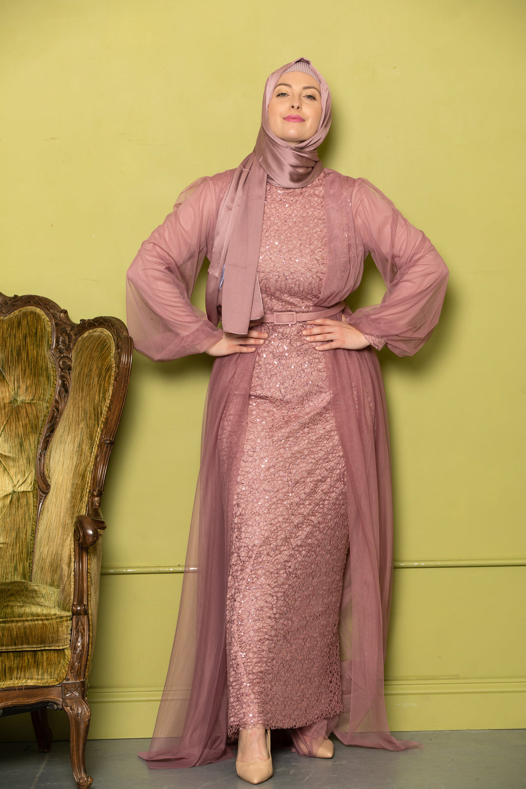 Woman in a mauve sequined hijab wearing a stylish chiffon overlay gown