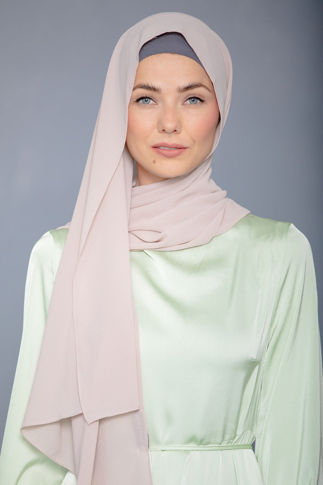 Woman in a latte chiffon hijab and elegant satin maxi dress as a stunning look