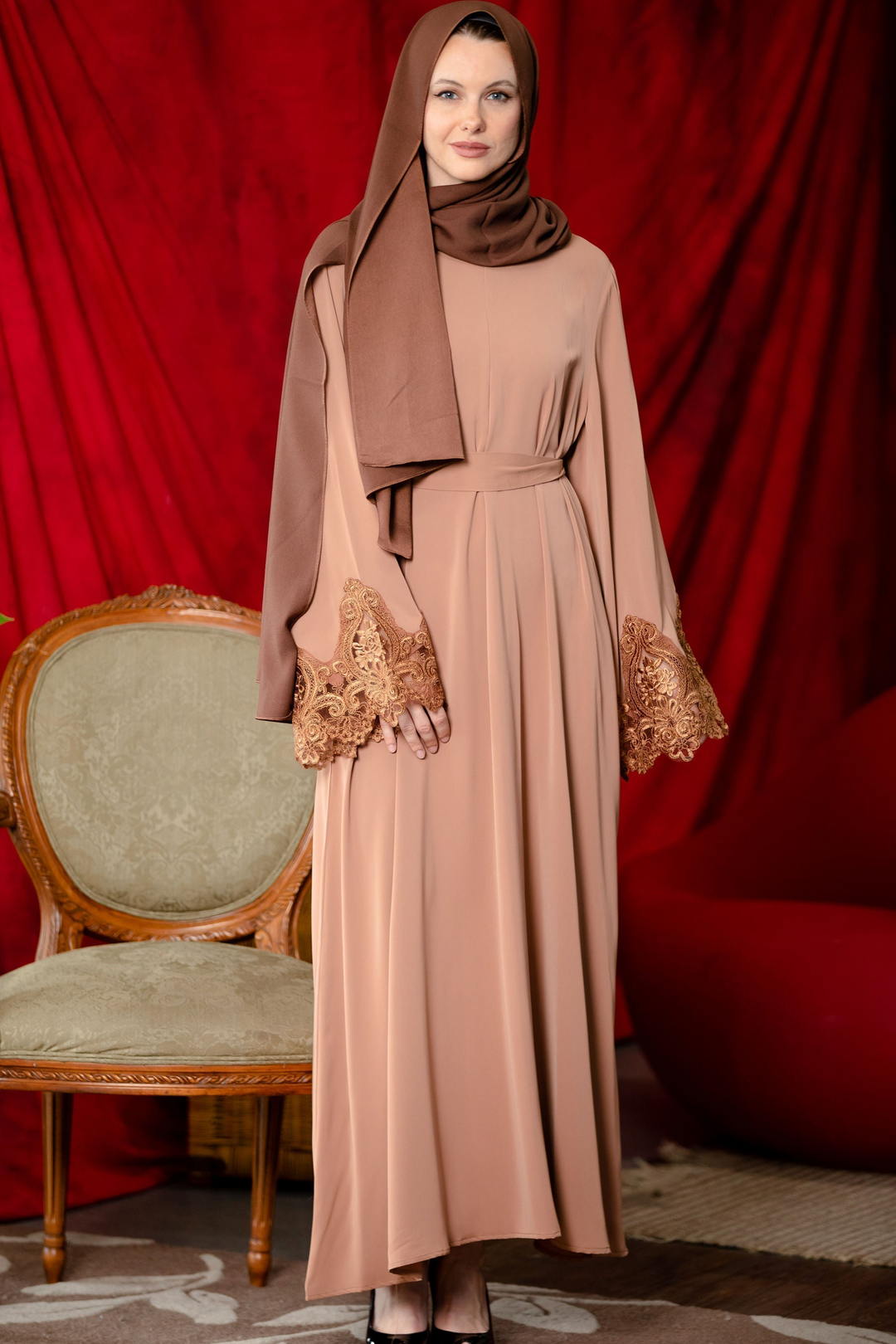 Woman in brown lace sleeve zipper abaya dress with hijab showcasing elegant modest fashion