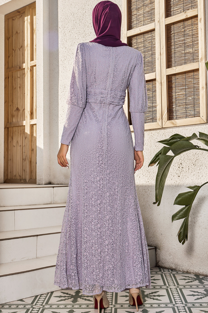 Lavender lace ruched waist long sleeve gown with hijab on a model