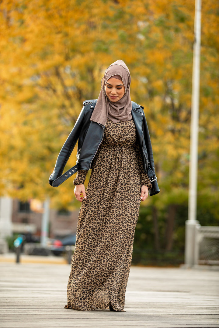 Woman in a leopard print maxi dress with elastic cuffs and stylish hijab