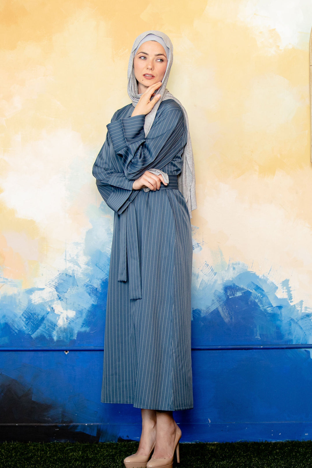 Woman in a Light Blue Pinstripe Kimono Sleeve Abaya showcasing stylish design and comfort