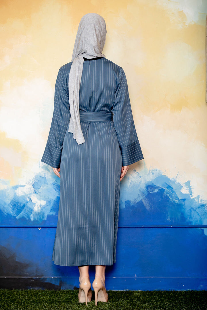 Blue pinstripe kimono sleeve abaya with belted design and matching hijab on display