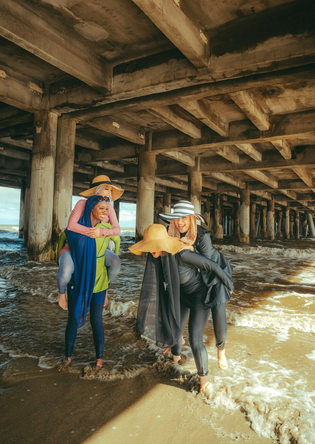 Women enjoying a beach day in a Lime Green 3 Piece Modest Swimsuit giving piggyback rides