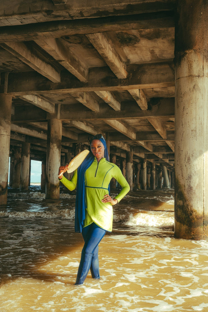 Woman in a burkini holding a paddle in a Lime Green 3 Piece Modest Swimsuit