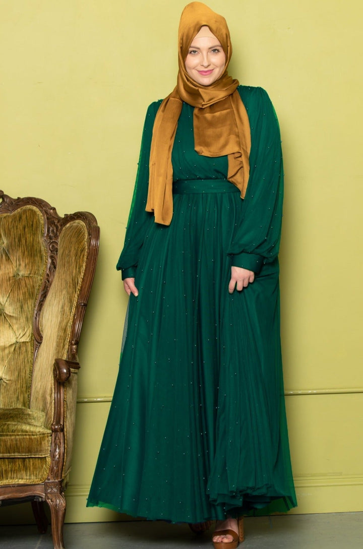 Emerald green mesh pearl long sleeve gown with a gold hijab for a modest look