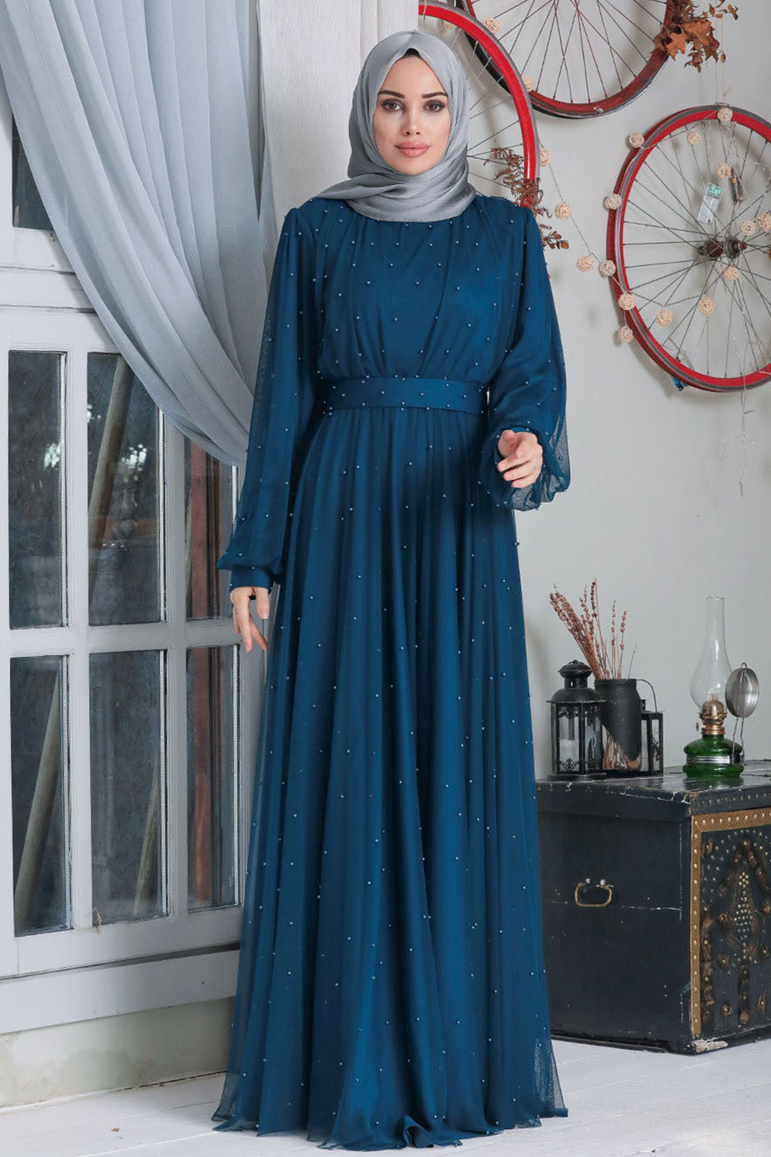 Teal beaded modest dress showcasing a Mesh Pearl Long Sleeve Gown design