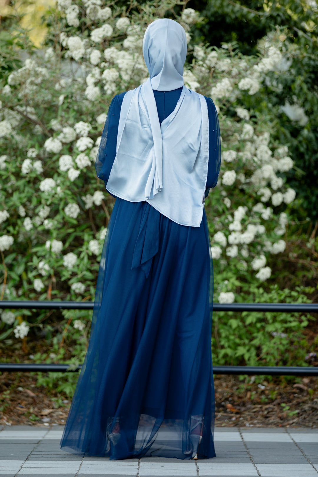 Woman in blue dress and hijab wearing a Mesh Pearl Long Sleeve Gown