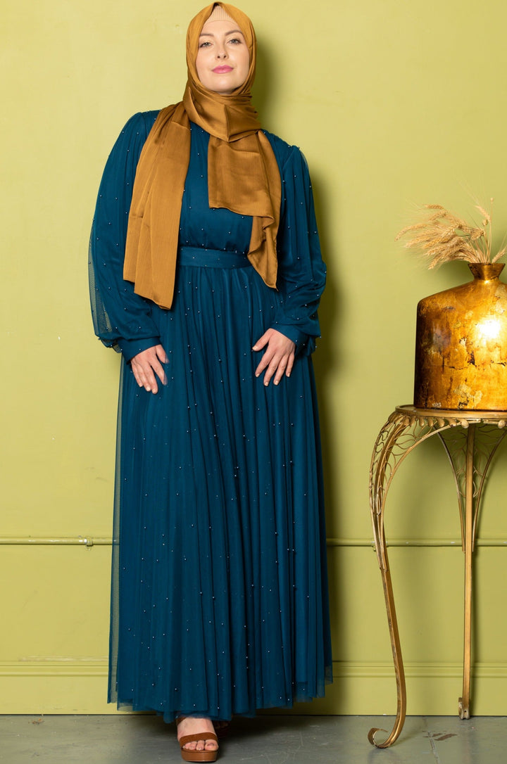 Woman in teal Mesh Pearl Long Sleeve Gown with gold hijab for stylish elegance