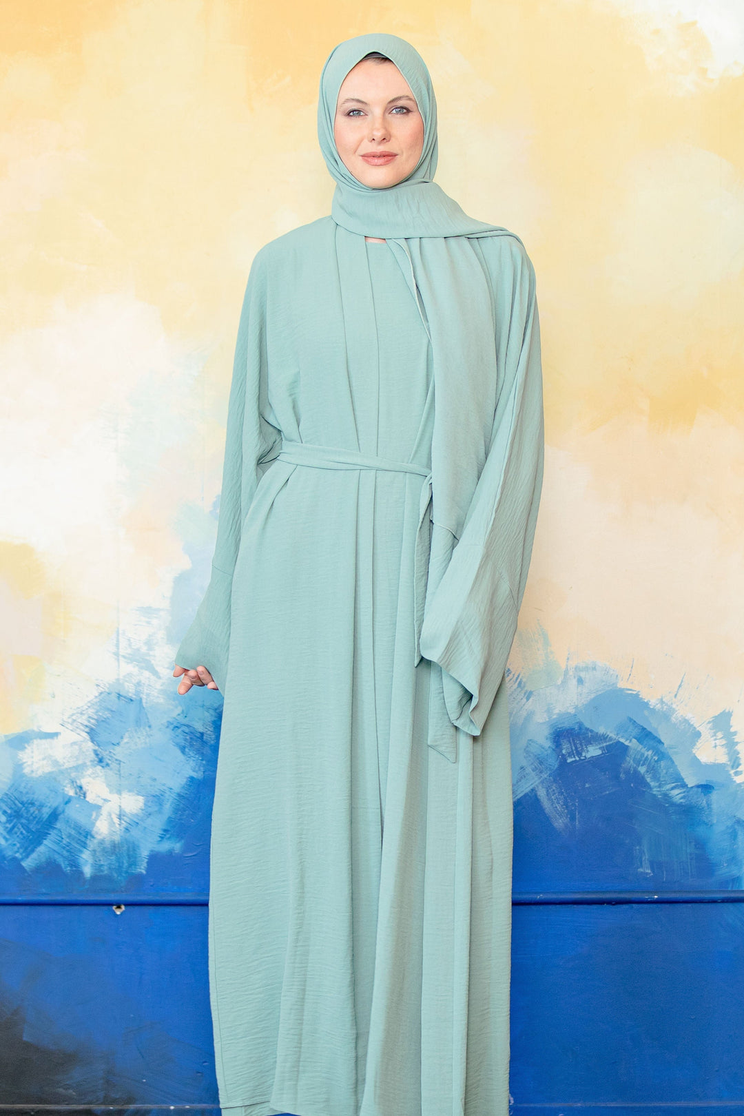 Mint green modest dress with hijab in a Mint Four Piece Open Abaya Set display