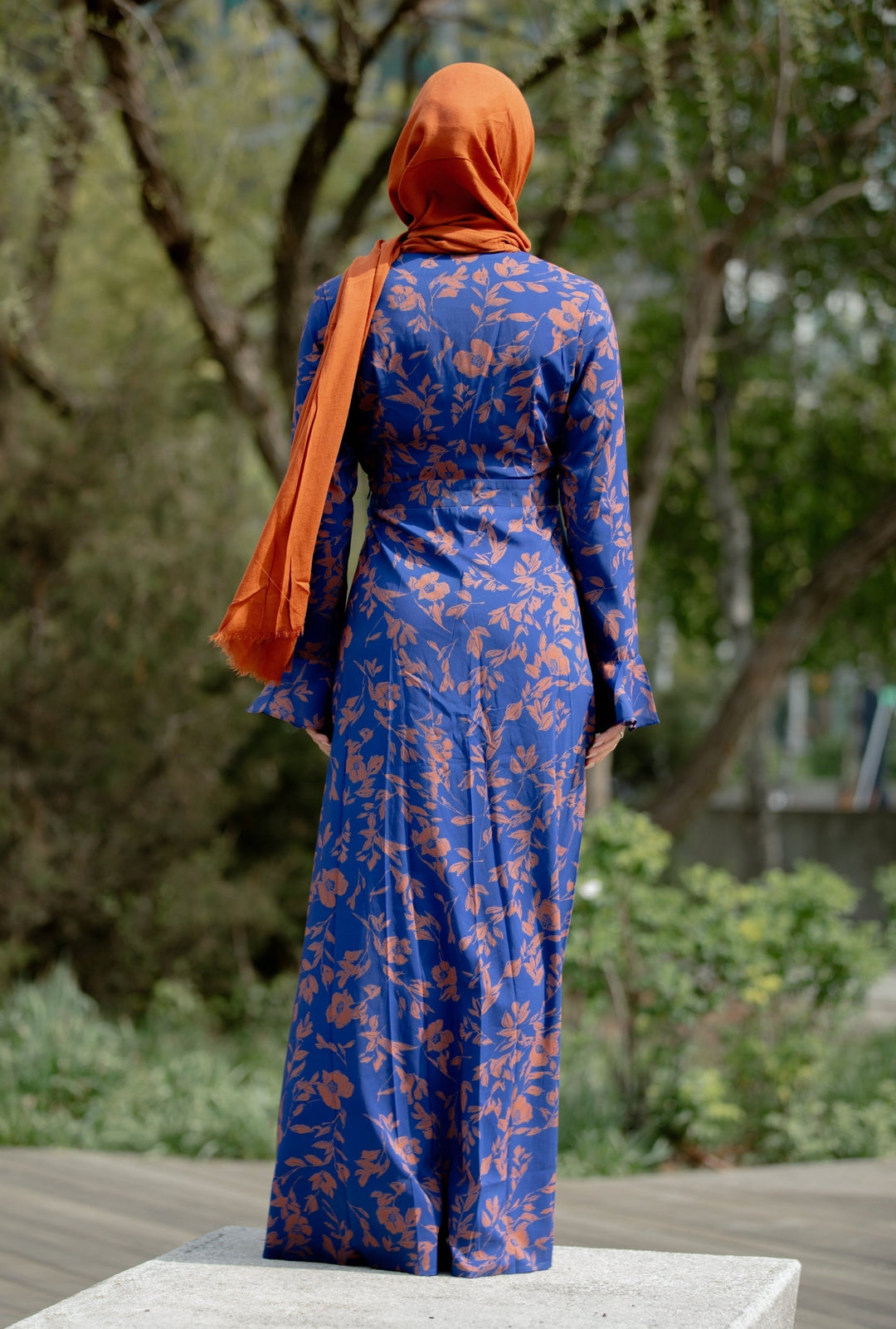 Blue floral maxi dress paired with orange hijab, showcasing Caramel Flutter Long Sleeve style