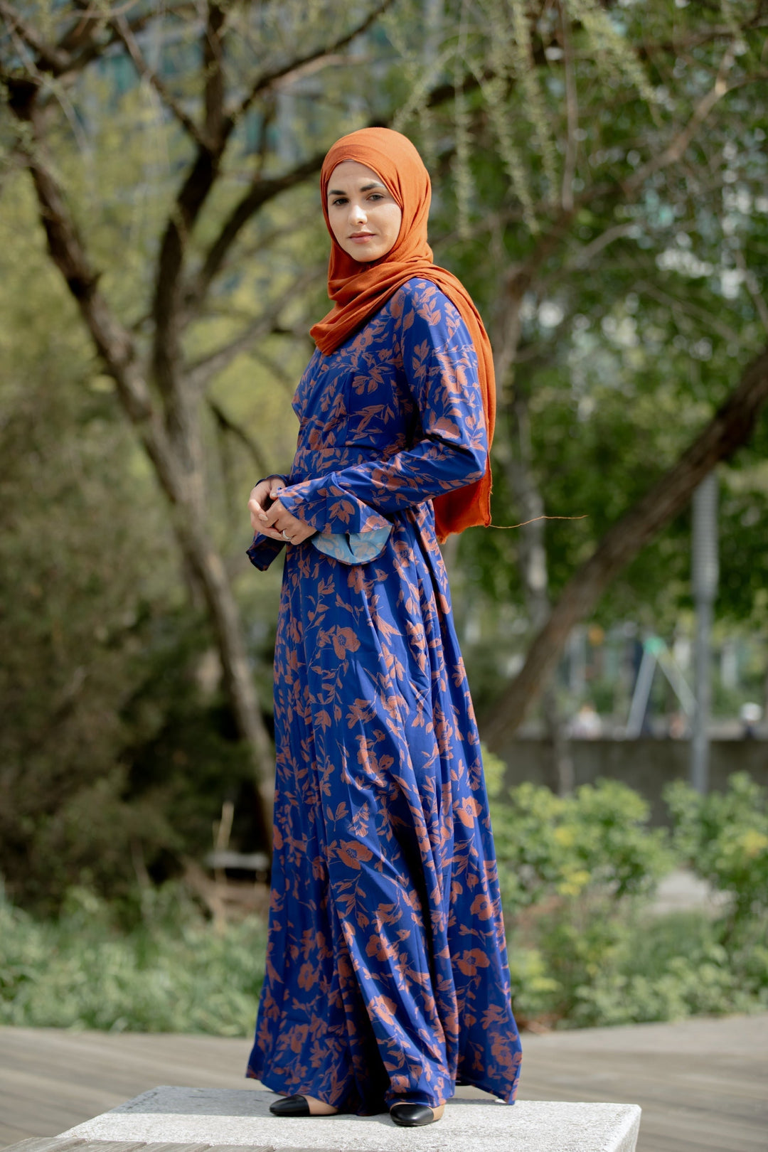 Blue floral maxi dress with orange hijab, showcasing a Caramel Flutter Long Sleeve design