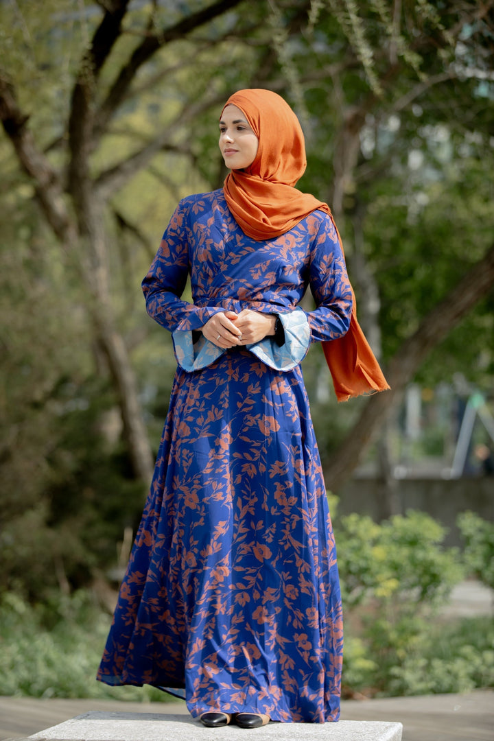 Blue floral dress with orange hijab in a Caramel Flutter Long Sleeve Maxi Dress