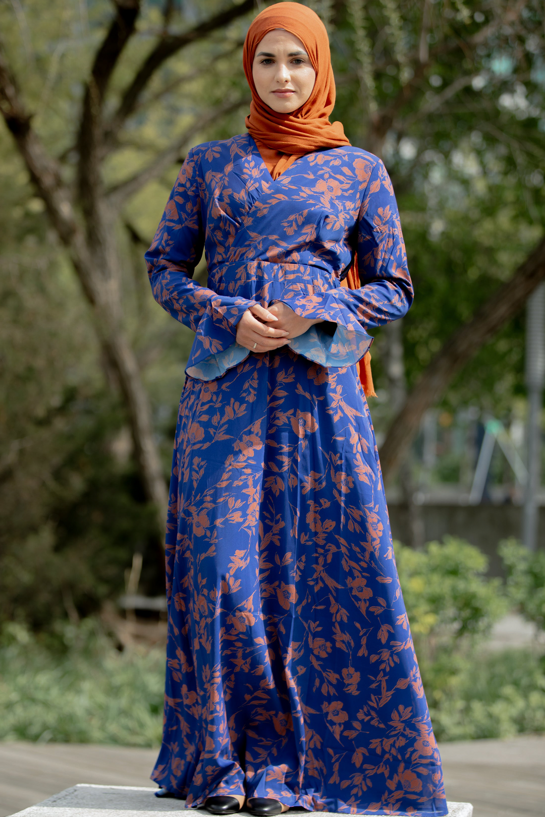 Blue floral print modest dress featuring a caramel flutter long sleeve design