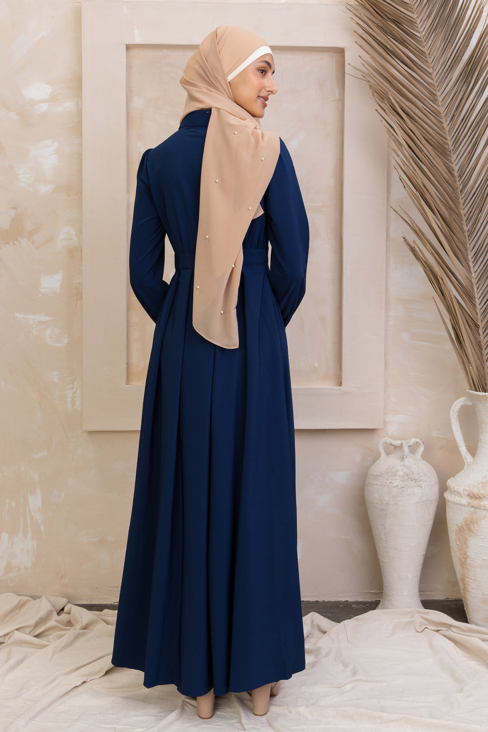 Woman in Navy Blue Lattice Abaya Maxi Dress with beige hijab showcasing elegant style