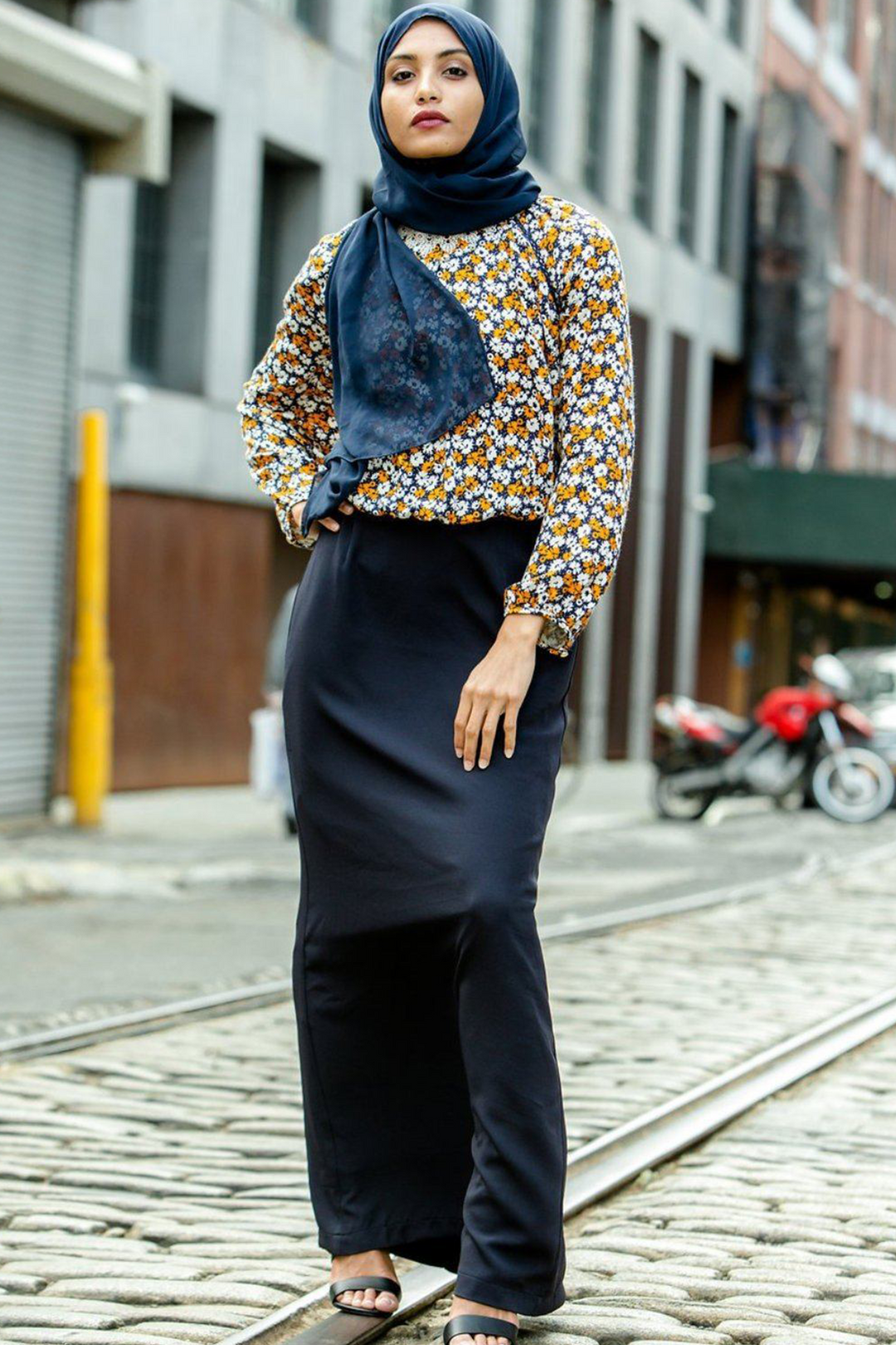 Woman in floral blouse paired with Navy Blue Pencil Maxi Skirt on clearance