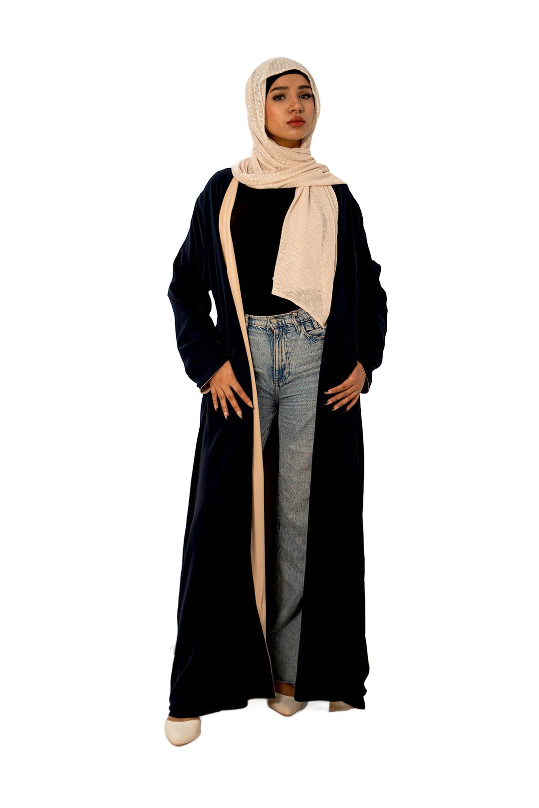 Woman in a black abaya and beige hijab, showcasing reversible open maxi dress style