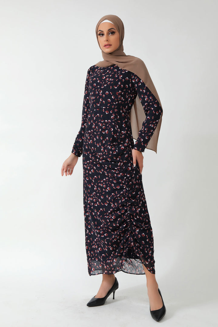 Woman in floral ruched maxi dress with adjustable ruching and stylish hijab