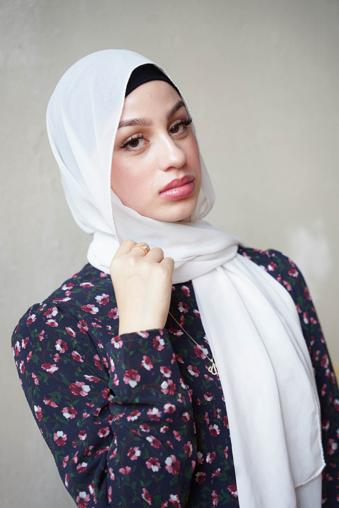 Woman in white hijab showcasing Navy Floral Ruched Maxi Dress with adjustable ruching