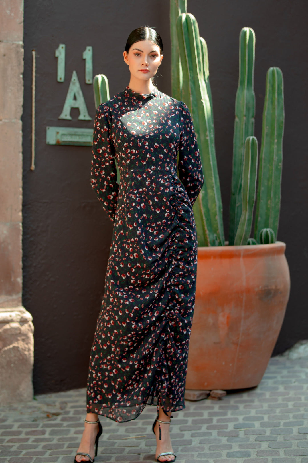 Woman in a Navy Floral Ruched Maxi Dress featuring adjustable ruching details