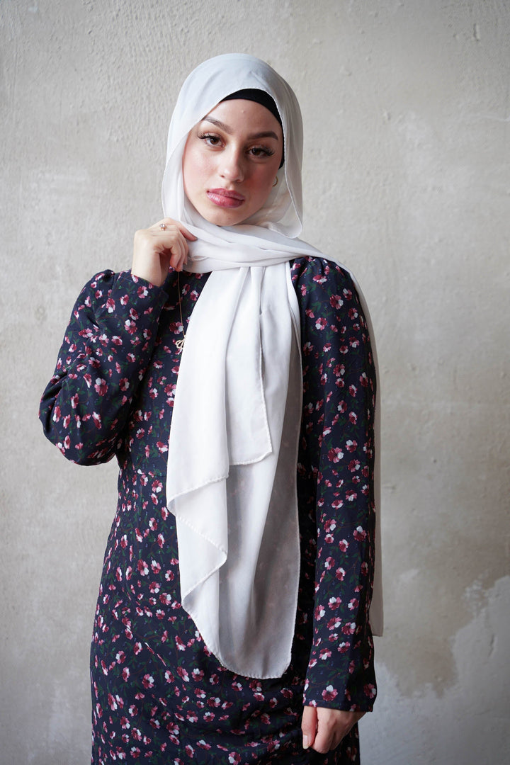 Woman in a floral ruched maxi with adjustable ruching and white hijab