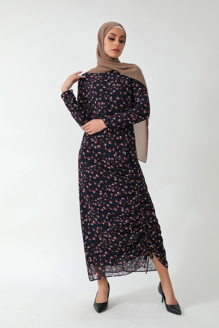 Woman in a Navy Floral Ruched Maxi Dress with adjustable ruching and stylish hijab