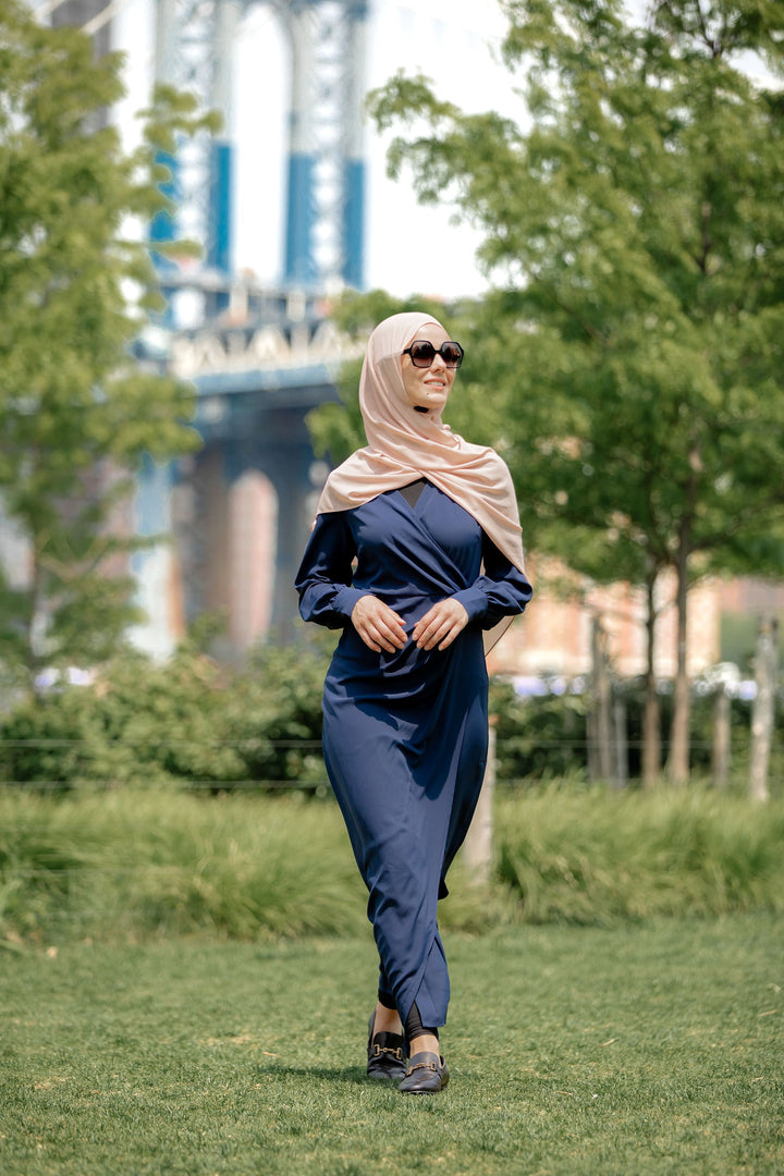 Woman in hijab wearing dusty purple wrap maxi dress with criss cross neckline