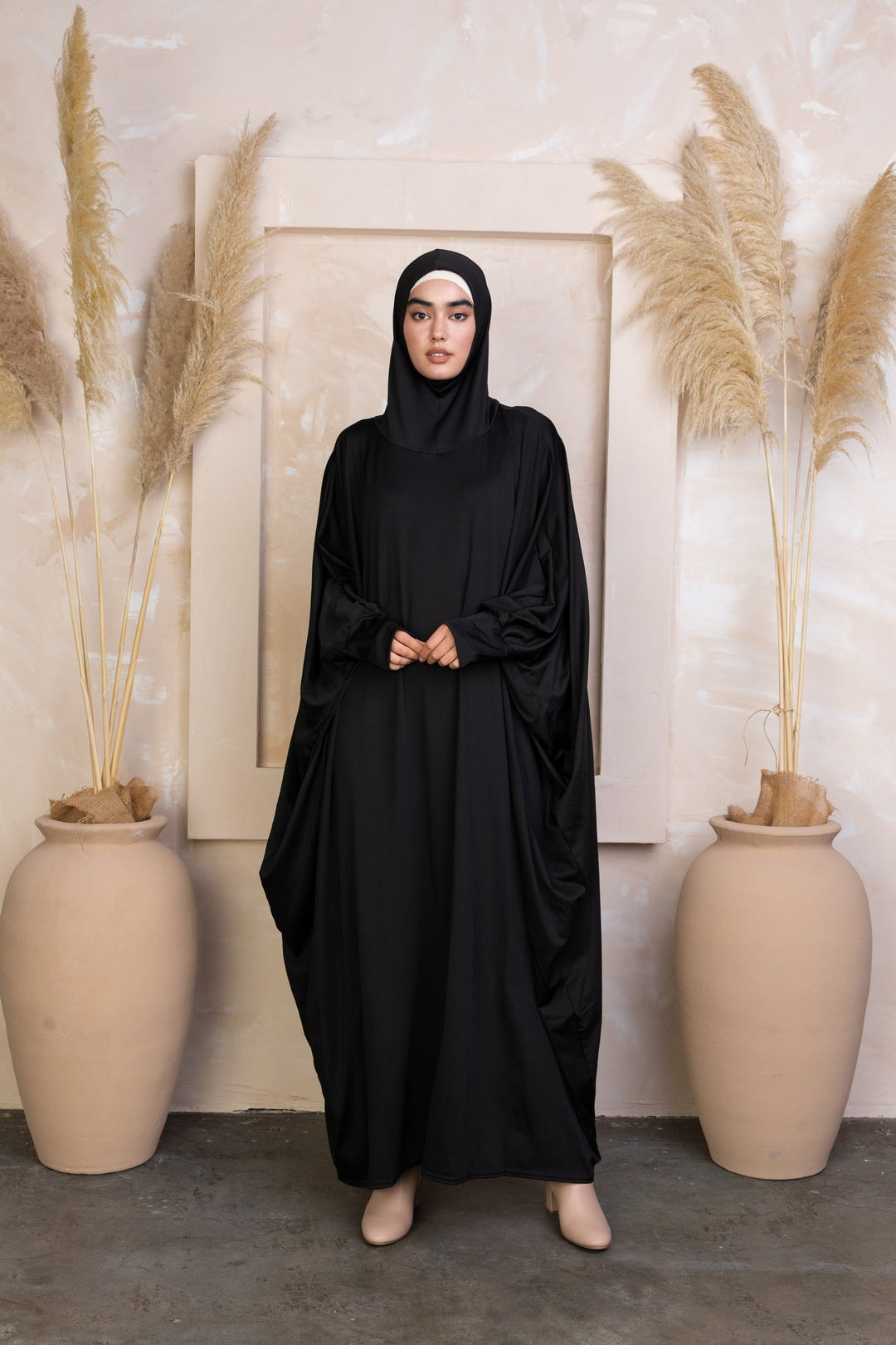 Black loose-fitting abaya with attached hijab, perfect for Salah outfit in breathable material