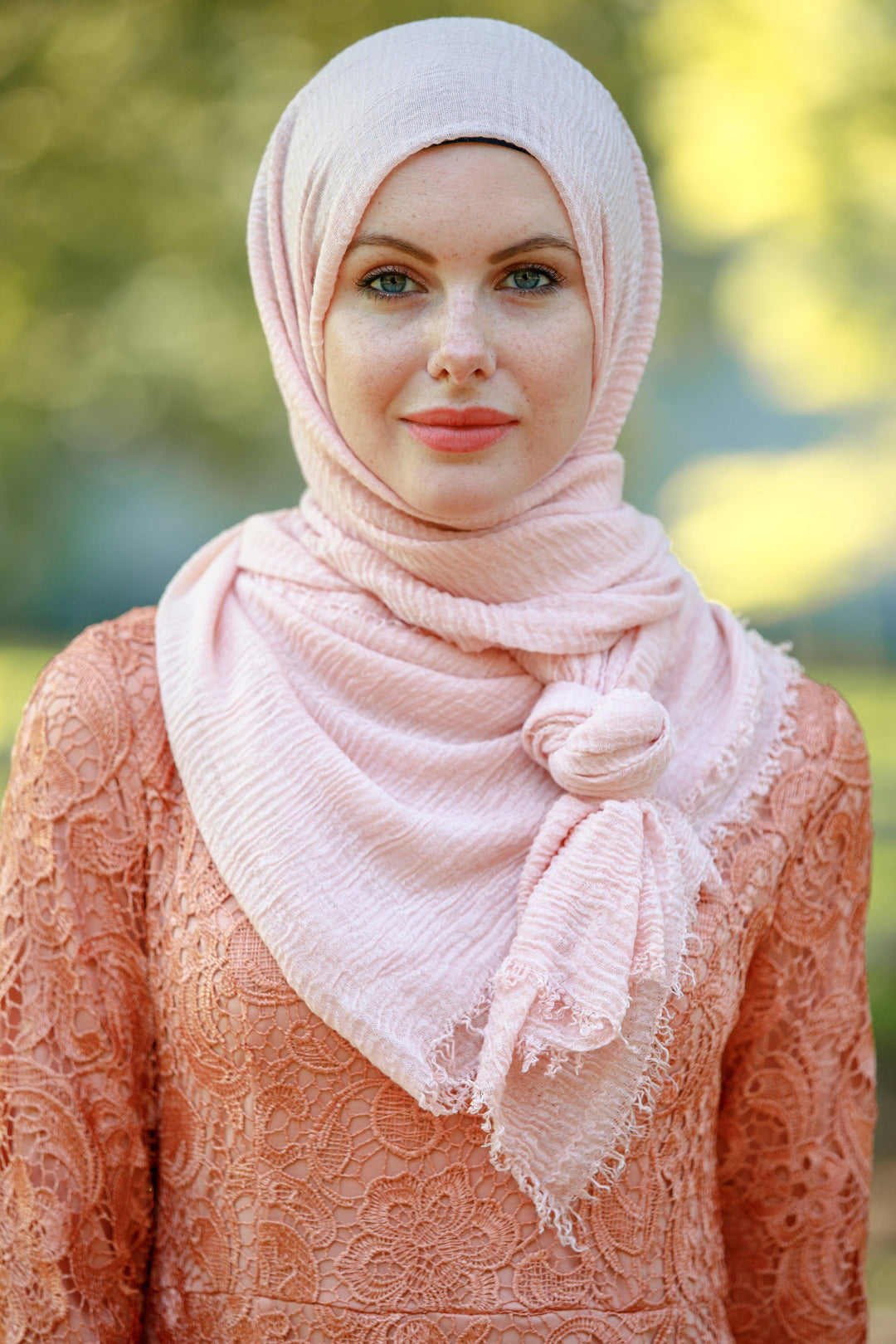 Woman wearing a Pale Pink Cotton Hijab and matching dress in elegant style