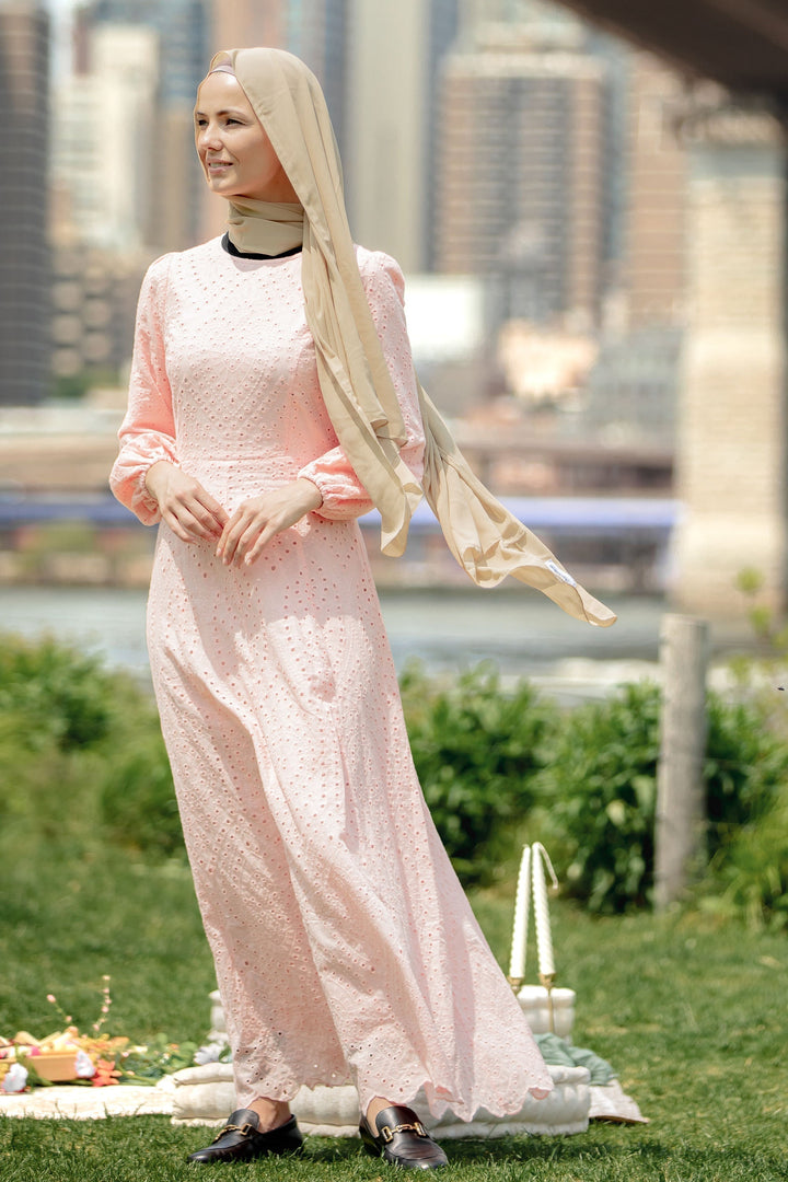 Woman in a pink eyelet long sleeve maxi dress with hijab showcasing the Peach Eyelet Maxi Dress