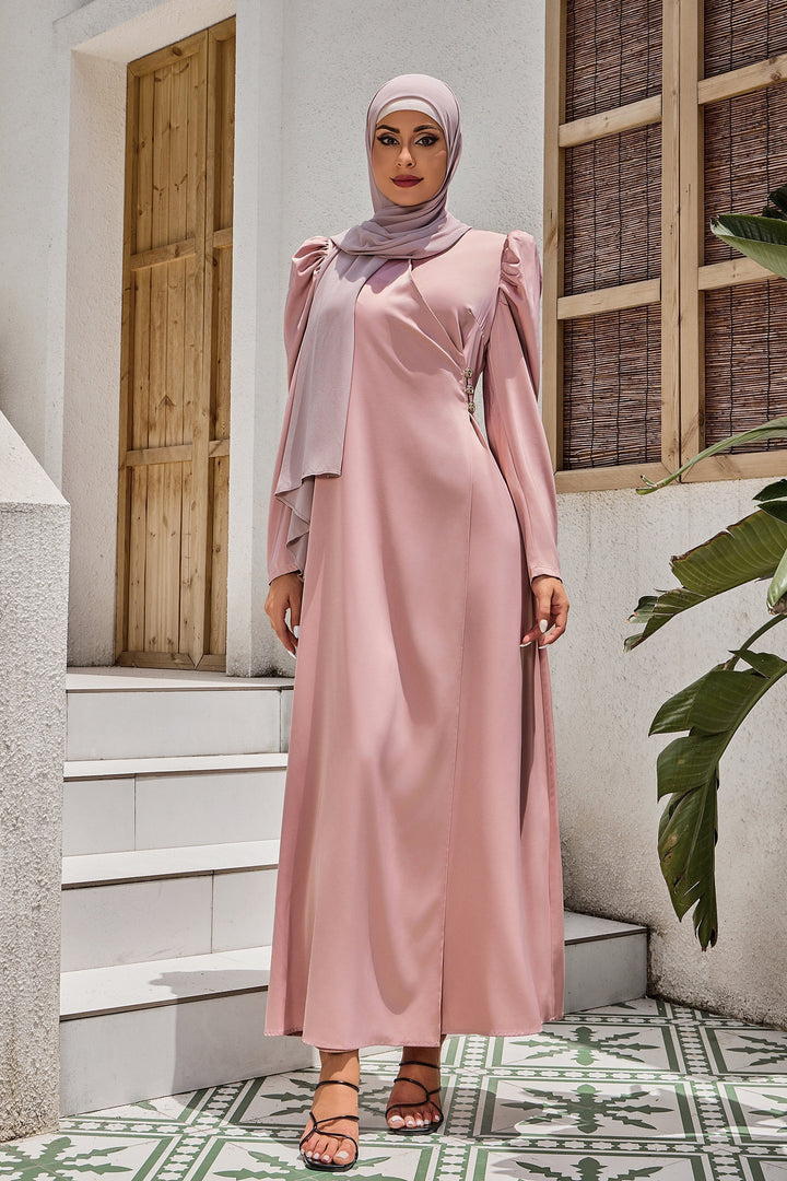 Woman in a long-sleeved pink dress and hijab showcasing Pink Criss Cross Puff Sleeve Maxi Dress