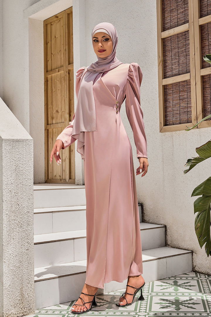 Woman in a long pink dress showcasing the Pink Criss Cross Puff Sleeve Maxi Dress