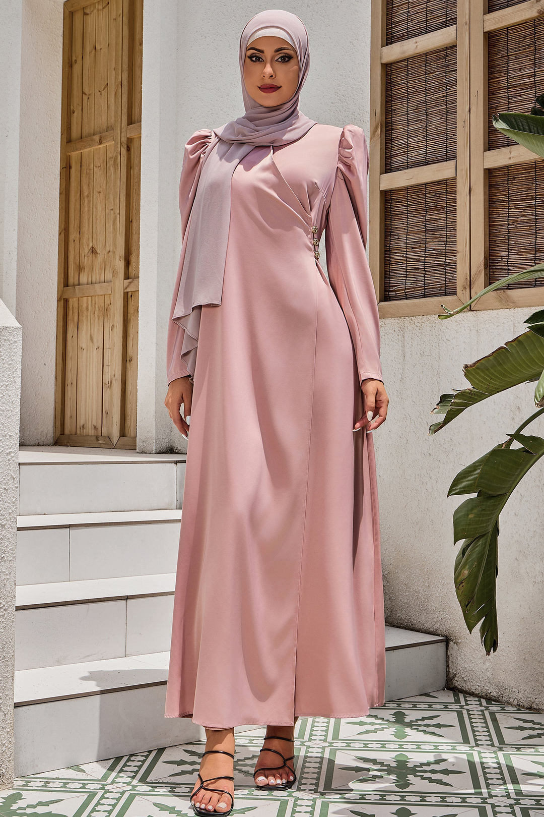 Woman in a pink criss cross puff sleeve maxi dress with hijab on clearance