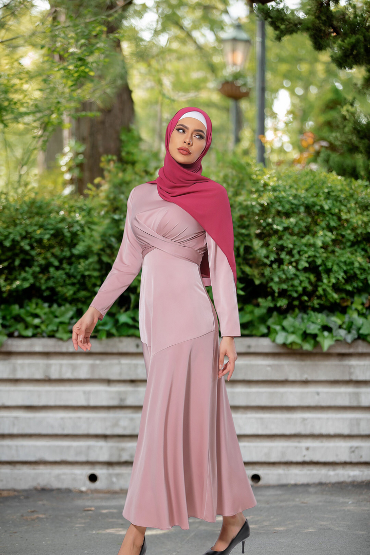 Woman in pink criss cross dress and maroon hijab, showcasing stylish maxi fashion