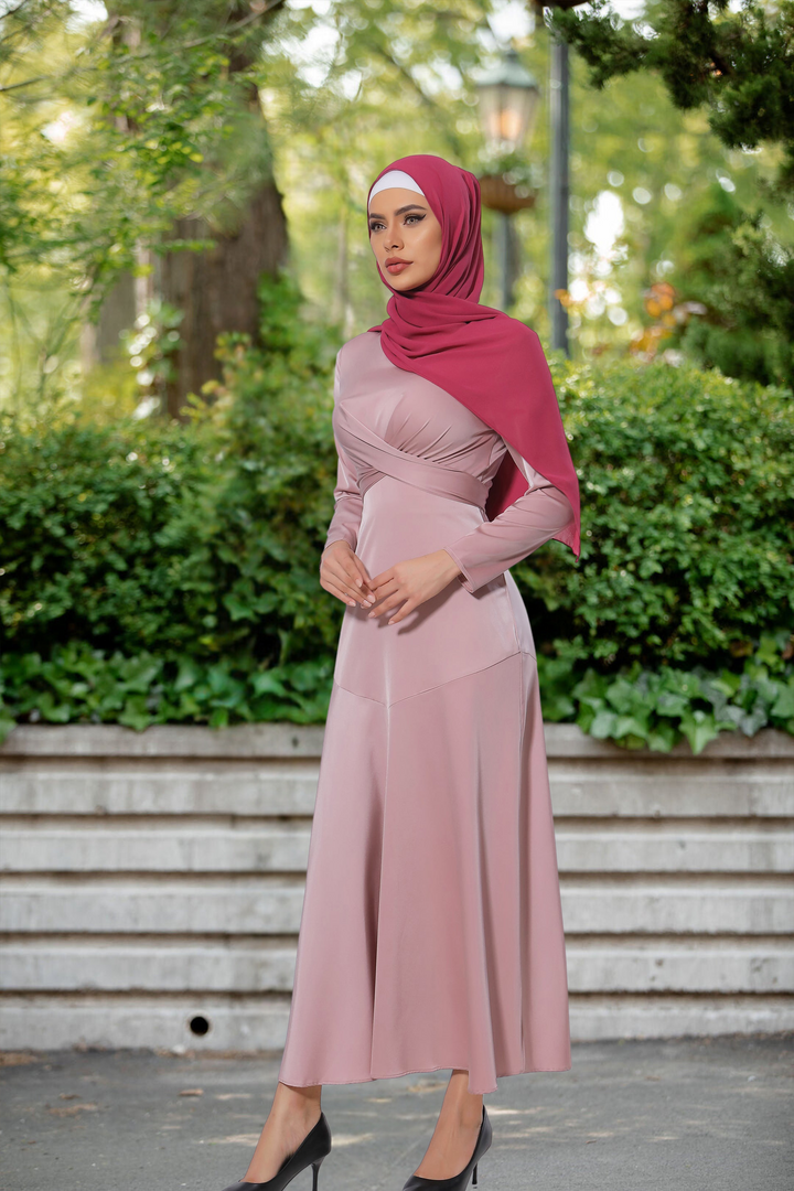 Woman in a pink dress and hijab showcasing Pink Criss Cross Satin Long Sleeve Maxi Dress