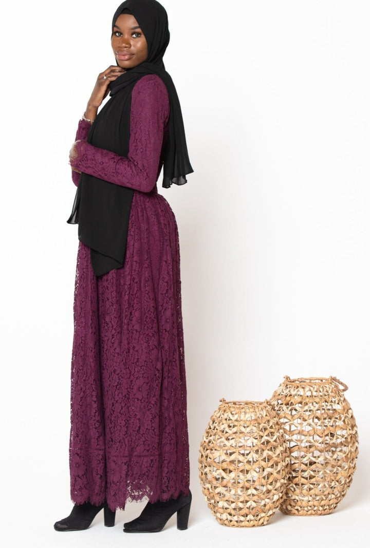 Woman in Plum Zahra Lace Long Sleeve Maxi Gown with guipure lace and zipper closure