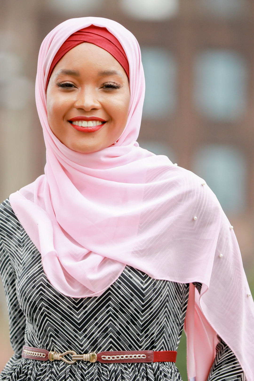 Smiling woman in pink hijab showcasing Powder Pink Pearl Chiffon Hijab