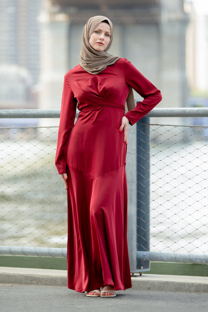 Burgundy long-sleeved dress with hijab showcasing red criss cross satin style