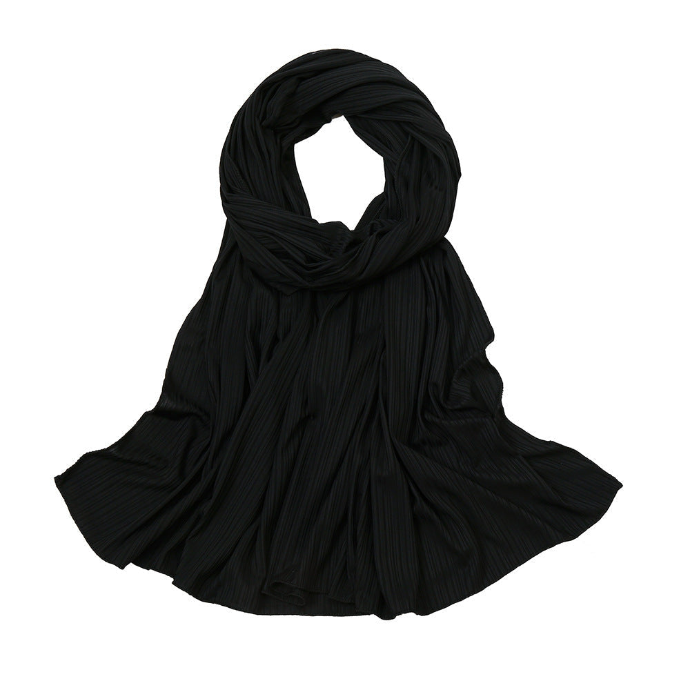 Black pleated scarf showcasing a ribbed jersey texture in stylish hijab design